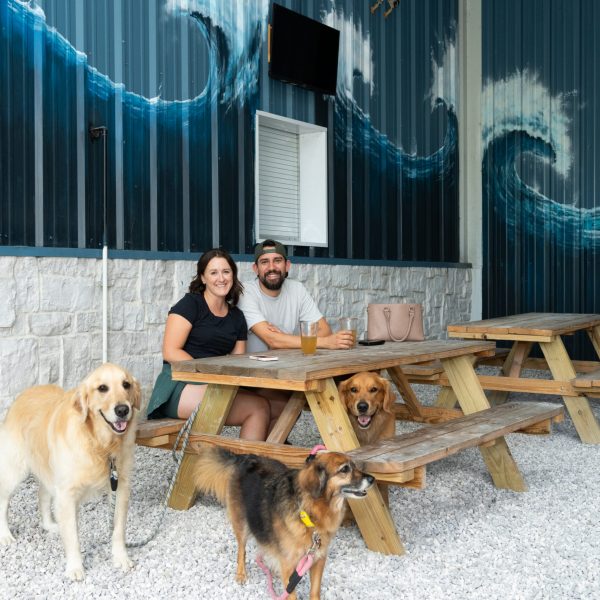 Couple enjoys a beer with their dogs at pet friendly taproom Vallensons Brewing Company